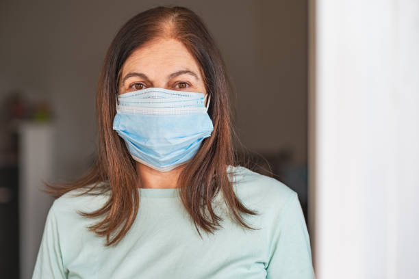 istock Senior woman getting ready to go out with triple mask! 1320460135