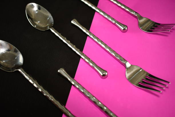 istock silver ware fork and spoon on a bright black and pink napkin close up beautiful abstract 1320460828