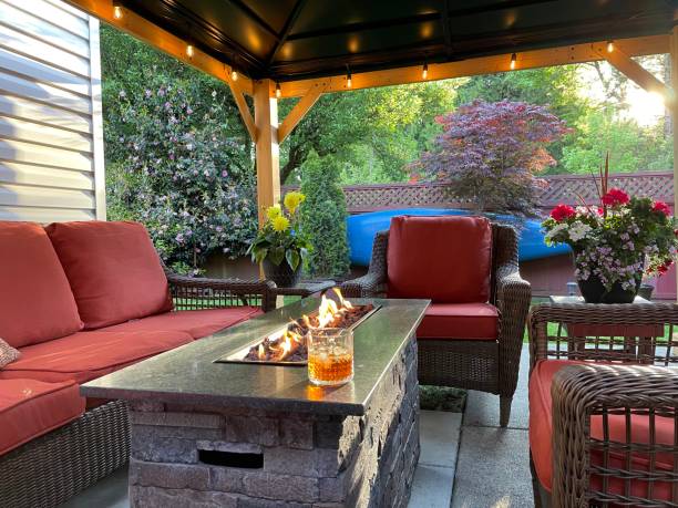 Cocktail drink on the backyard patio Cocktail in the backyard with a gas fireplace, patio lights and deck chairs back yard stock pictures, royalty-free photos & images