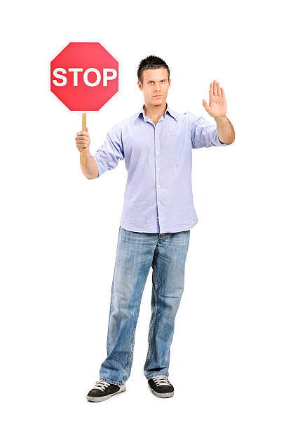 istock Man gesturing and holding a traffic sign stop 132046117
