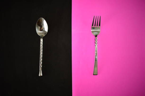 istock silver ware fork and spoon on a bright black and pink napkin 1320462601