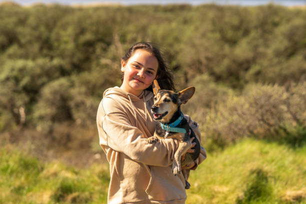 istock Thirteen year old with pet terrier outdoor portrait 1320463802