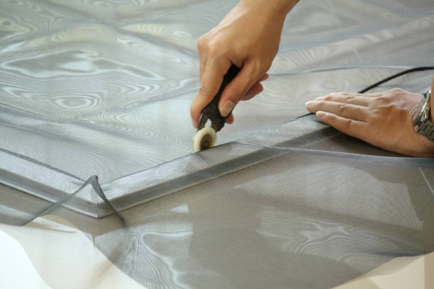 istock man install mosquito net wire screen on house window protection against insect 1320467104