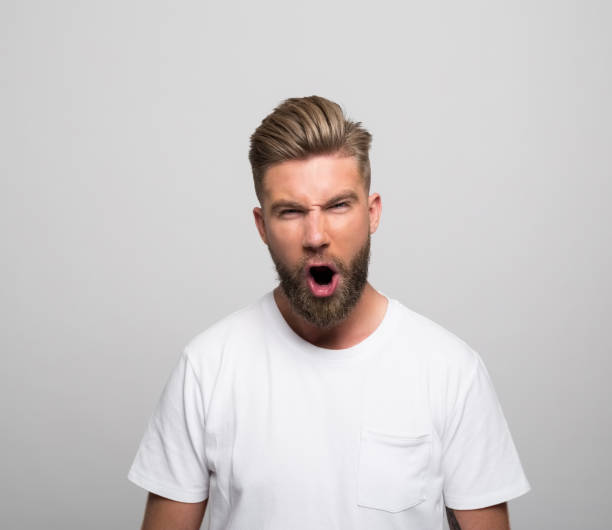 istock Headshot of angry young man 1320467658
