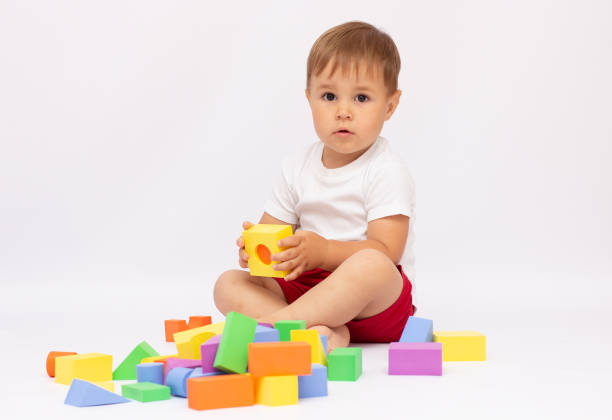 istock cheerful kid boy with construction set over white background 1320467680