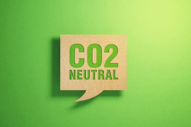 Sustainability Concept - CO2 Neutral Written Chat Bubble Made of Recycled Paper Sitting On Green Background CO2 neutral written chat bubble made of recycled paper on green background. Horizontal composition with copy space. Sustainability concept. carbon neutrality photos stock pictures, royalty-free photos & images
