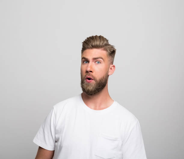 istock Headshot of surprised young man 1320467858