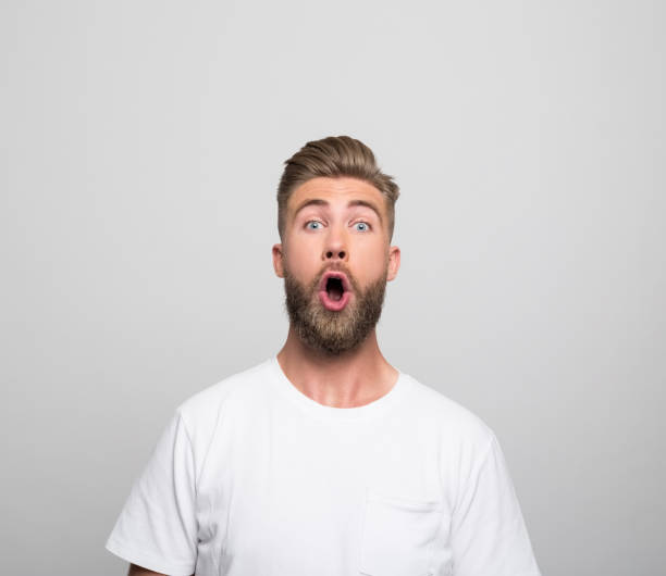 istock Headshot of surprised young man 1320468386