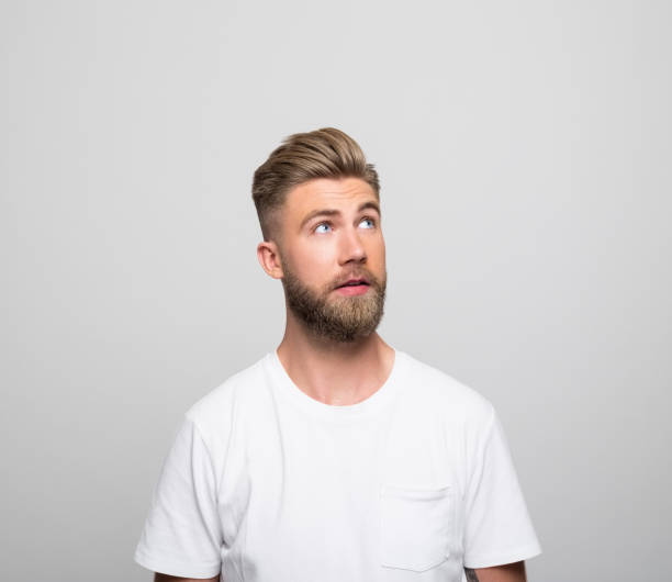 istock Headshot of surprised young man 1320468415