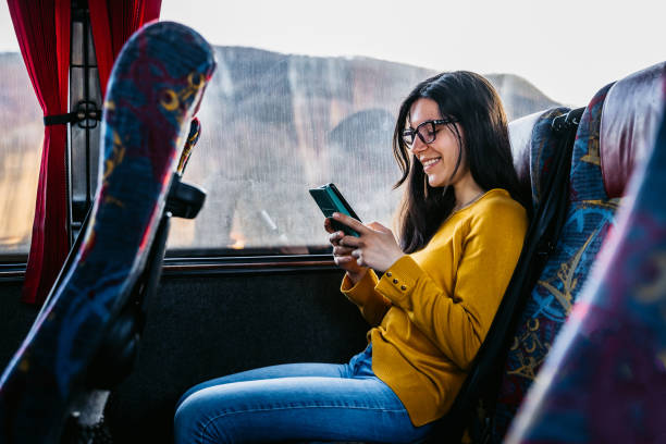 istock Woman reading news on phone while traveling 1320470185