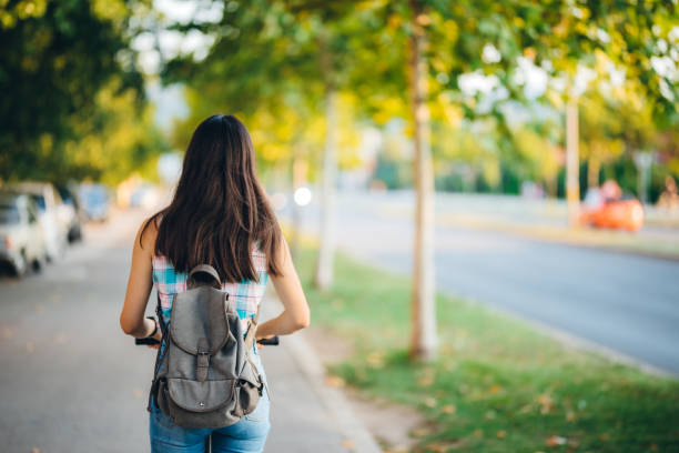 istock Young woman driving electric scooter 1320471455