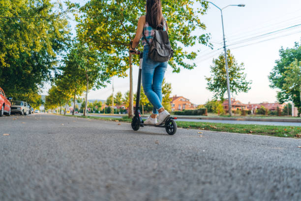 istock Young woman driving electric scooter 1320471866