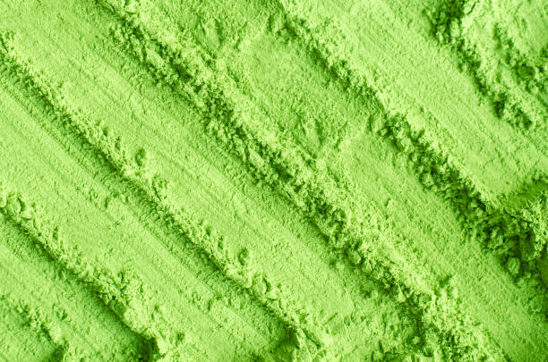 istock Matcha powder background. Green tea texture close up, selective focus 1320473933