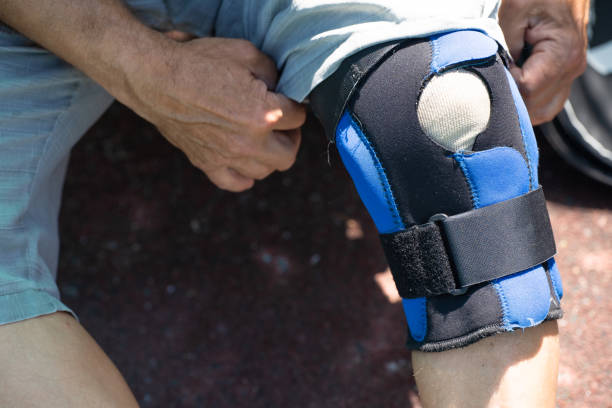 istock Man puts on a protective bandage on his leg 1320474153