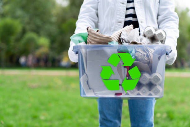 istock Volunteer holding paper garbage container for recycling 1320474657