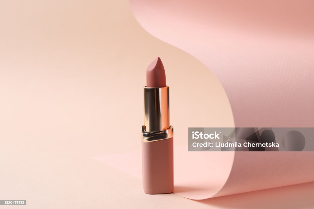 Beautiful lipstick on beige background. Professional makeup product Lipstick Stock Photo