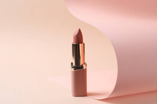 Beautiful lipstick on beige background. Professional makeup product Beautiful lipstick on beige background. Professional makeup product lipstick stock pictures, royalty-free photos & images