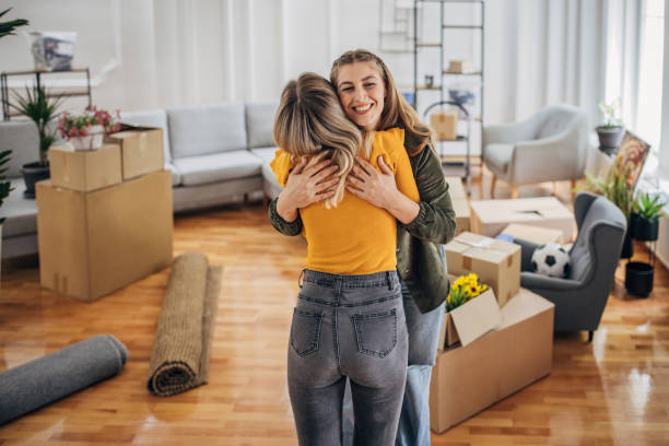 istock Lesbian couple hugging in new home 1320476050