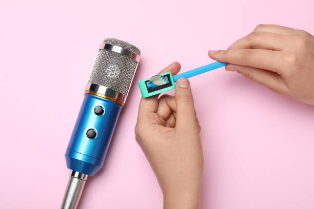 istock Woman making ASMR sounds with microphone, pencil and sharpener on pink background, top view 1320477186