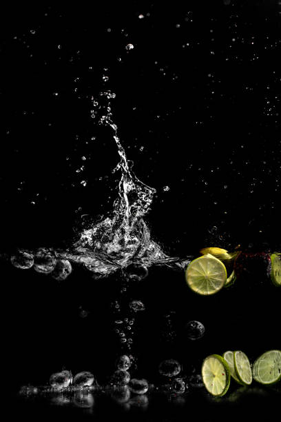 splash of water with fruits on a black