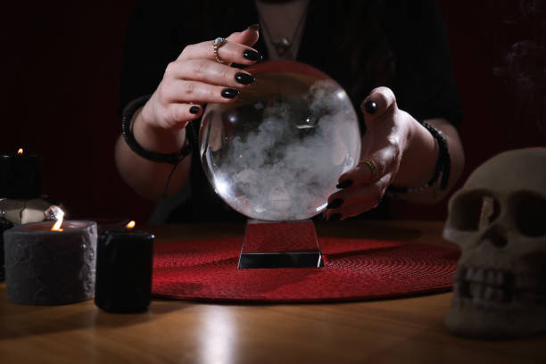 istock Soothsayer using crystal ball to predict future at table indoors, closeup 1320478442