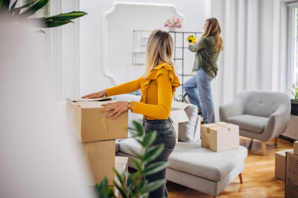 istock Lesbian couple unpacking in new home 1320478784