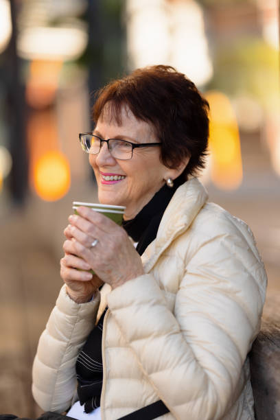 istock Smiling woman with a takeaway coffee 1320479549
