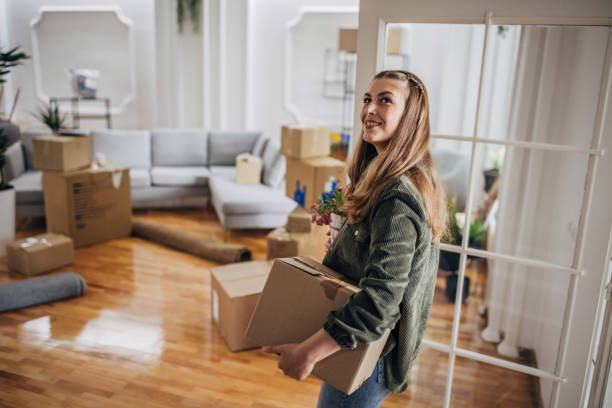 istock Woman moving in new apartment 1320482154