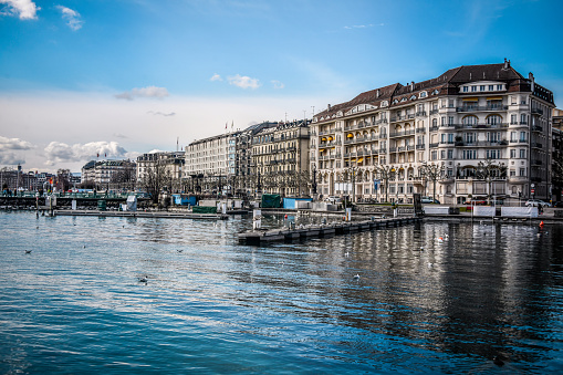 Pier On Lake Geneva And Apartment Buildings, Switzerland