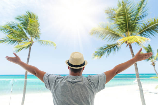 istock Man in summer hat enjoying vacation at balcony 1320482564