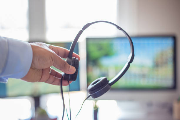 istock businessman with headphones at work 1320483354