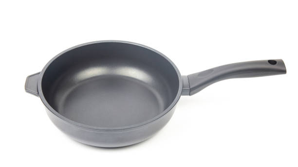 istock Black frying pan with non-stick teflon coating on white background 1320483461
