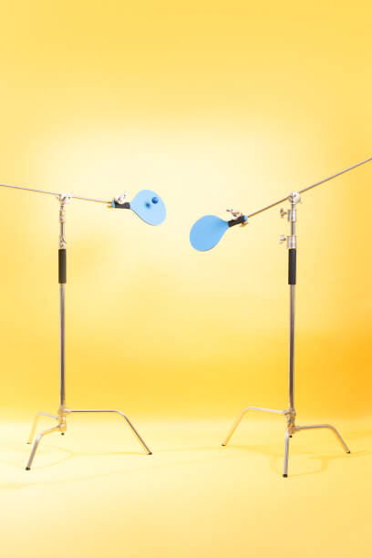 istock set of blue beach paddles fixed on tripods on a yellow background. vertical image. 3D illustration 1320483570
