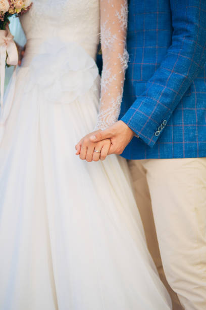 istock Midsection Of Couple Holding Hands 1320487043