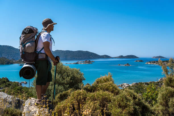 istock Backpacker watching Mediterranean view with walking pole on high rocky ground 1320487147