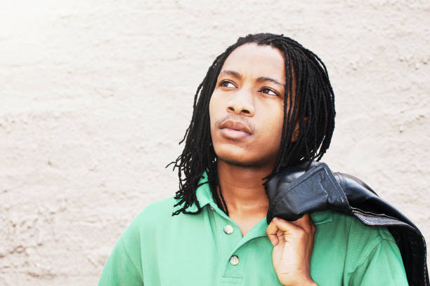 istock Handsome young man with dreadlocks looks serious and thoughtful, with copy space 1320487269