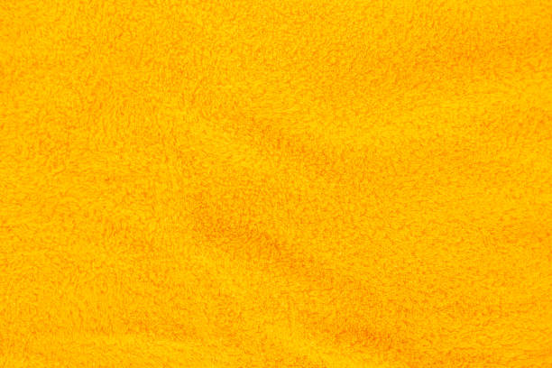 istock Yellow terry bath towel fabric background. 1320488576