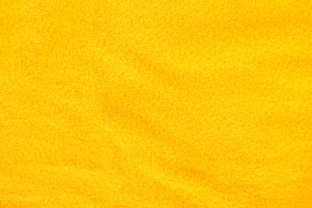 istock Yellow terry bath towel fabric background. 1320488660