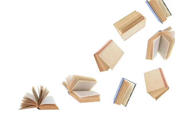 Pattern of books in different positions and located in the right-bottom part of the image. Isolated on a white background.