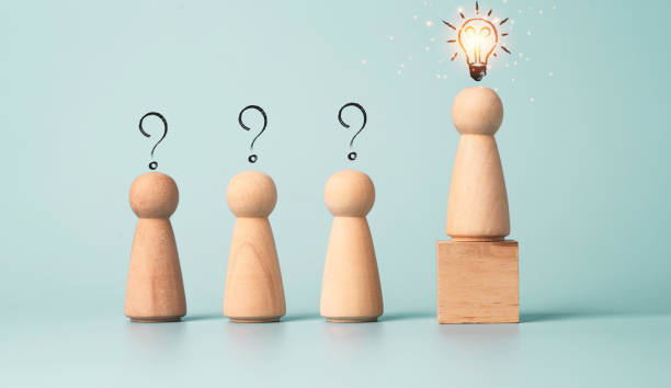 istock Wooden figure with drawing light bulb on cube among other wooden with question mark , Problem solving and creative idea  concept. 1320489733