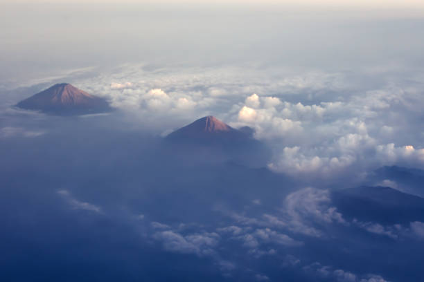 beautiful aerial view on a mountains or volcano from the plane - mountain range earth sky airplane imagens e fotografias de stock