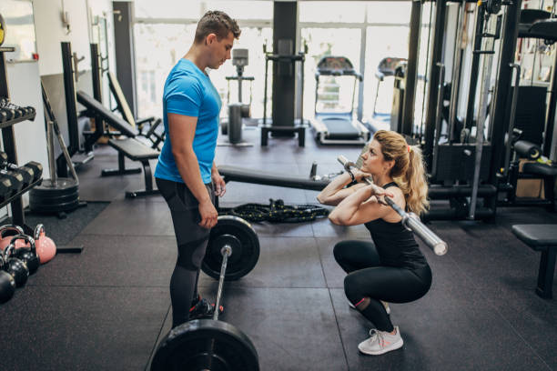 istock Man exercising with fitness trainer 1320490846