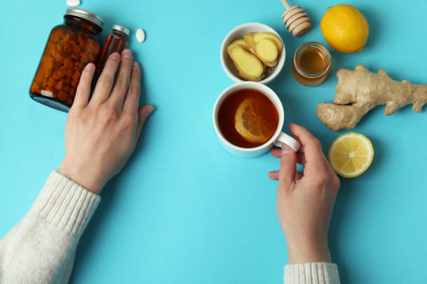 istock Female hands and alternative medicines on blue background, top view 1320492539