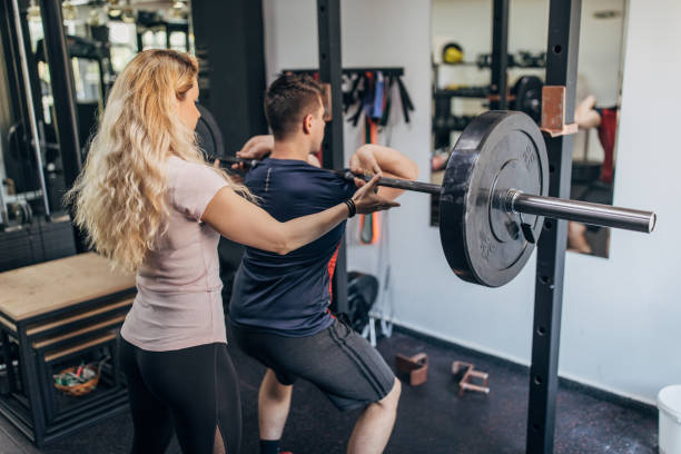 istock Man exercising with fitness trainer 1320492758