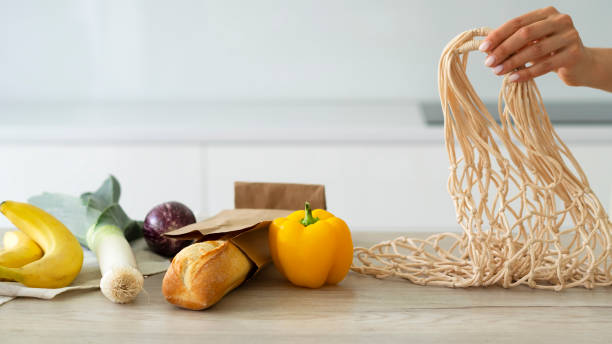 istock Zero waste, eco friendly concept. Women's hands hold shopping reusable mesh bag. 1320494196