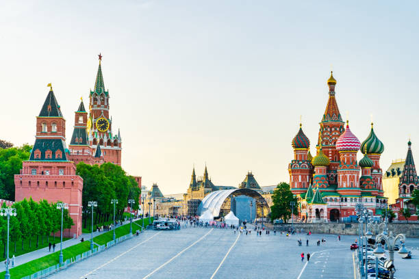 The Moscow Kremlin and Red square panorama in sunset. Sunset in Moscow - view to The Kremlin and Red square from Bolshoy Moskvoretsky Bridge. Saint Basil's Cathedral and GUM are on the background. red square stock pictures, royalty-free photos & images