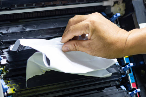 istock Technicians Removing Paper Stuck, Paper Jam In Printer At Office 1320496230