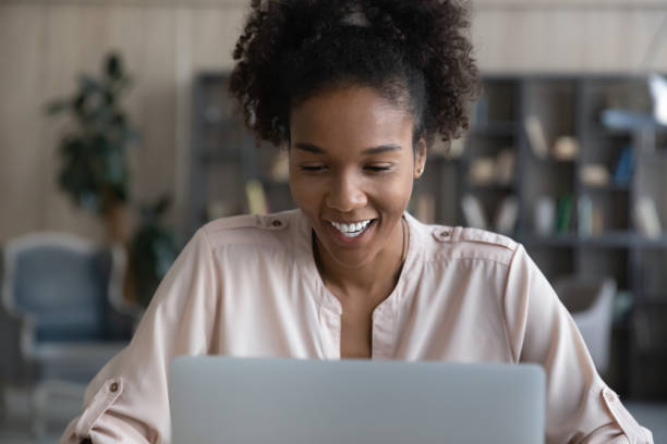istock Happy young african american woman working on computer. 1320497151