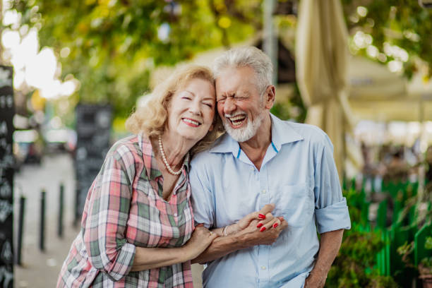 istock Senior couple holding hands and enjoying walking on a nice sunny day 1320497193