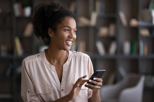 istock Happy young african american woman using smartphone. 1320497973